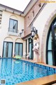 A woman standing on the edge of a swimming pool.