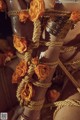 A close up of a woman tied up with rope and flowers.