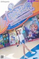 A woman standing in front of a sign that says Chimelong Paradise.